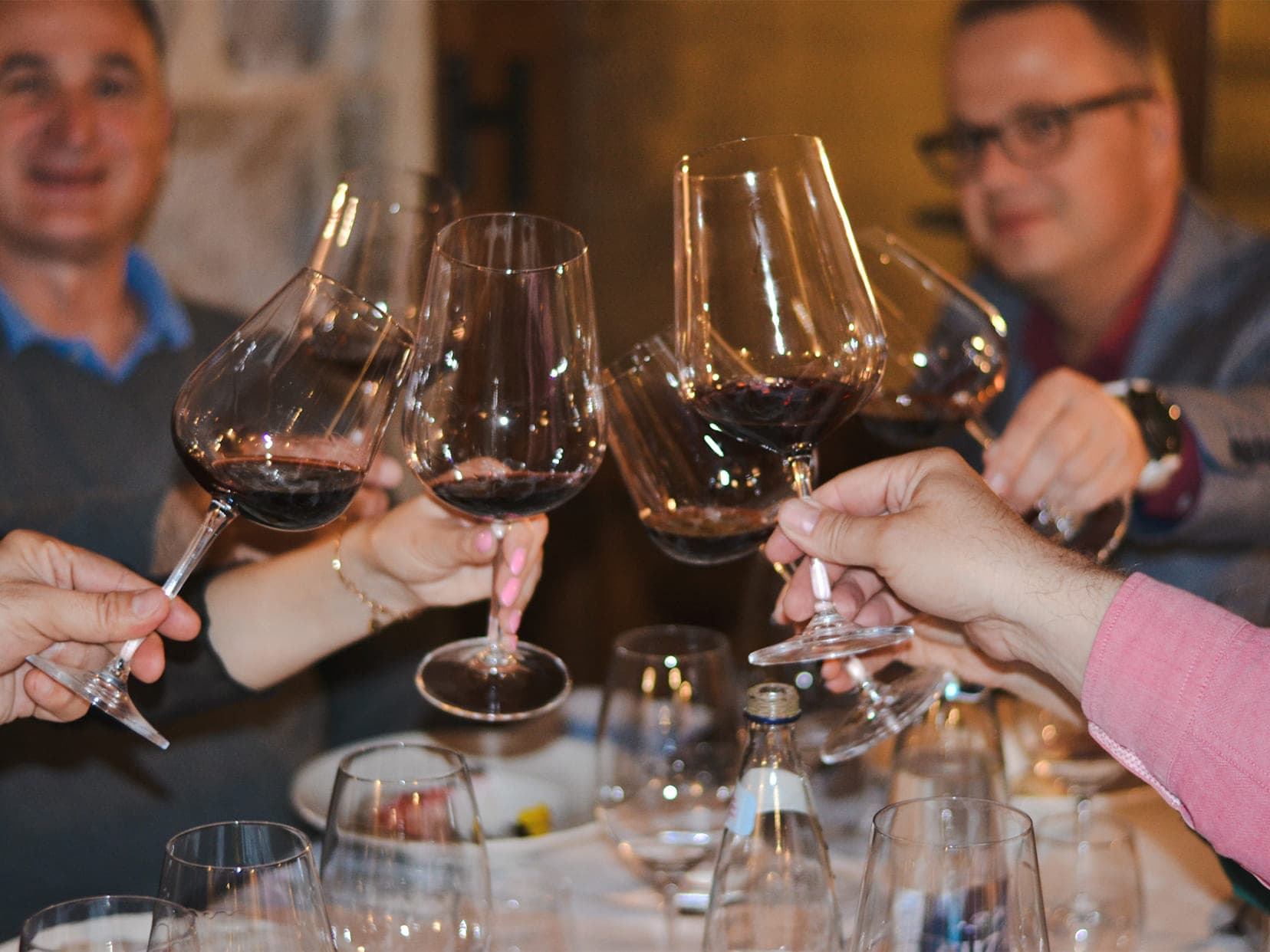 Guests of Conte restaurant clinking wine glasses