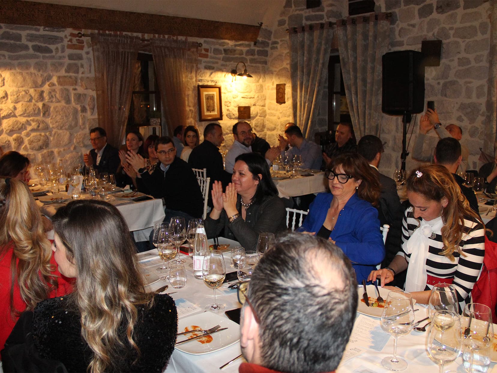 Guests of Conte restaurant clapping during dinner
