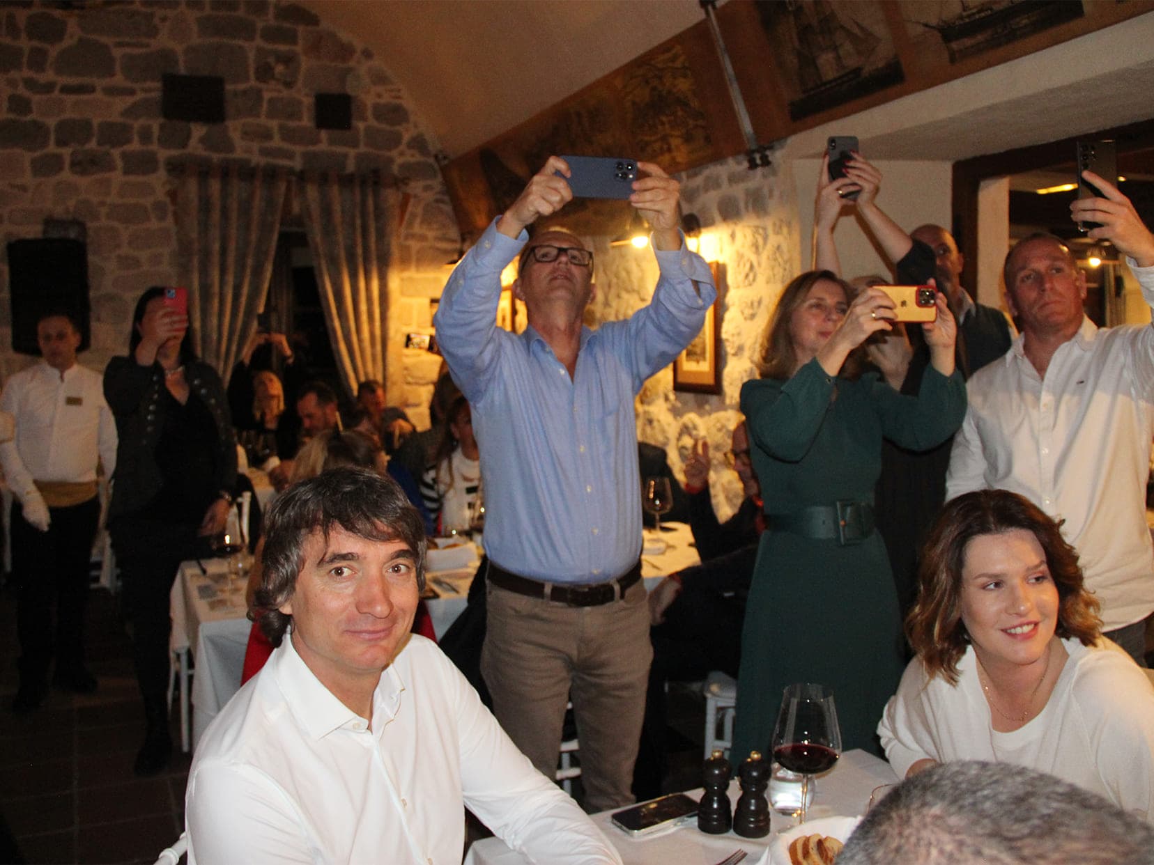 Guests of Conte restaurant taking photos during dinner